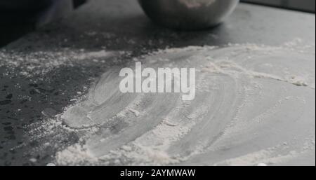 sprinkles flour on countertop surface, wide photo Stock Photo