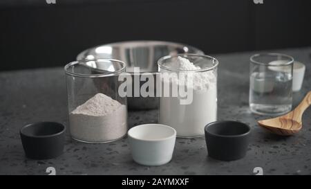 dry ingredients with flour in steel bowl on concrete countertop, wide photo Stock Photo