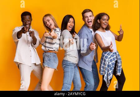 Cheerful multiracial group of students indicating at camera Stock Photo