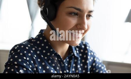 Smiling Indian call center agent consult client online Stock Photo