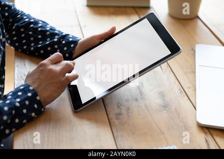 Close up of Indian female using tablet typing Stock Photo