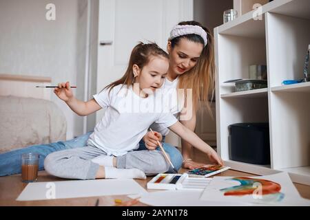 good looking kid choosing colours to paint a picture, close up photo. Stock Photo