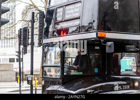 The Ghostbustour old London Routemaster bus painted black. Ghost Bus Tours retired London bus used for spooky transport around city. Dismembered arm Stock Photo