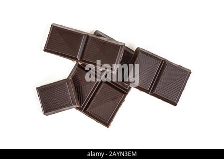 Dark chocolate pieces isolated on white background, with clipping path, flat lay. Carefully retouched. Stock Photo