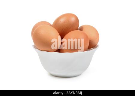 Brown eggs in white porcelan bowl isolated. Clipping path for easy cut out. Stock Photo