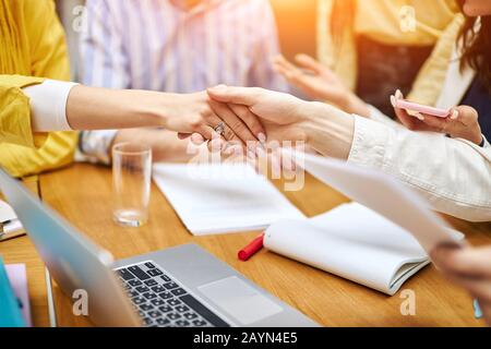 Cropped image of young women shaking hands, success, agrement. agreement. two companies negotiating a contract. Stock Photo