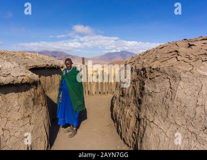 NGORONGORO, TANZANIA - AUGUST 16, 2019: Masai woman near her house. in a traditional Masai village near Arusha, Tanzania Stock Photo