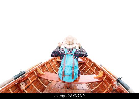 Traveler girl sitting in wooden canoe or kayak boat isolated on white Stock Photo