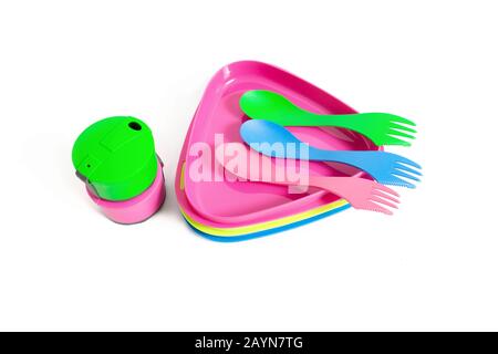 Multicolored plastic dishes and tableware eqipment isolated on a white background. Hiking kitchenware utensils concept Stock Photo