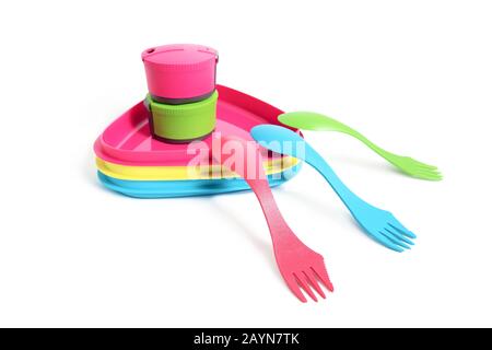 Multicolored plastic dishes and tableware eqipment isolated on a white background. Hiking kitchenware utensils concept Stock Photo