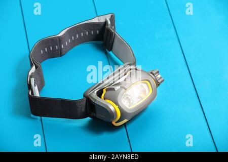 Camping Headlamp on blue table background Stock Photo