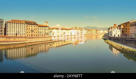 Wide panoramic view of the embankment of The Arno River in Pisa. Travel in Italy and Tuscany concept Stock Photo