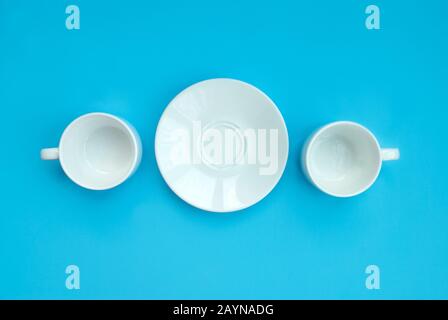 Conception good morning. Two white porcelain cups and saucers on a light claw background, top view. Copy space Stock Photo