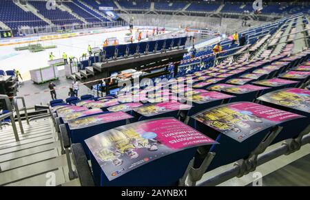 Berlin, Germany. 16th Feb, 2020. On the first day of the double game, the Mercedes Benz Arena will be converted from an ice hockey stadium to a basketball setup. After the grandstand is free of spectators, the ice surface is covered. The empty seats are already filled with new gossip boards for the cup final ALBA against EWE Oldenburg. Credit: Andreas Gora/dpa/Alamy Live News Stock Photo