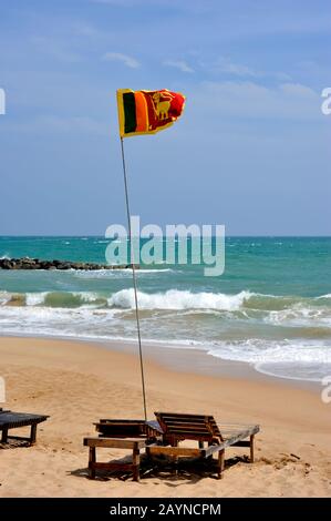 Sri Lanka, Tangalle beach, sri lankan flag and sunbeds Stock Photo