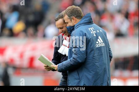 Koeln, Germany, RheinEnergieStadion, 16th Feb 2020: Manager Horst Heldt of Koeln talks and laughs with Head coach Hans-Dieter Flick of Muenchen prior the first Bundesliga match 1.FC Koeln vs. FC Bayern Muenchen in the season 2019/2020.  DFL regulations prohibit any use of photographs as image sequences and/or quasi-video. Credit: Mika Volkmann/Alamy Live News Stock Photo