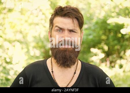 Eco lifestyle. United with environment. Handsome lumberjack. Man bearded  hipster green trees background. Guy relax in summer nature. Man beard and  mustache in summer forest. Summer vacation concept Stock Photo