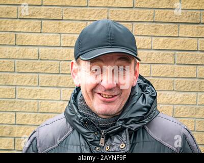 A man shows emotional facial expressions on his face. People. Winter clothes. Place for text. Outdoors Stock Photo