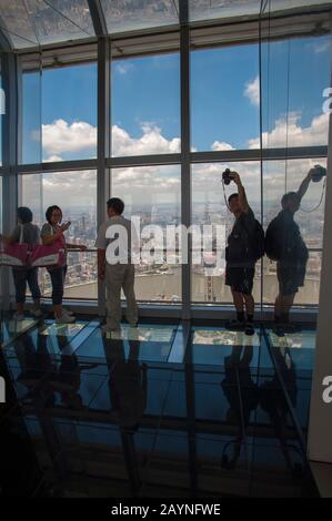 People at the observation platform of the 492 meter high World Financial Center in Pudong, Shanghai, China. Stock Photo