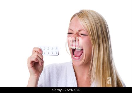Frau mit Pillenpackung im Mund Stock Photo