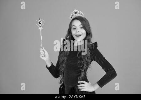 Something Special in Air. magic queen from fairytale. just make a wish. all dreams come true. airs and graces. royal and luxury. happy girl long curly hair in crown. little princess hold magic wand. Stock Photo
