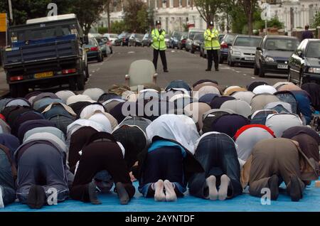 Atilla Ahmet aka abu abdullah leads Friday Prayers in the road outside a Mosque in Finsbury Park, North London following it's closure at the request of the police claiming it had become a meeting point for many radical Muslims. In 2003,150 anti-terrorist police officers conducted a night raid on the building seizing  a stun gun and a CS gas canister, arresting seven men under the Terrorism Act 2000. The Inman Abu Hamza continued to preach each Friday in the street outside the closed mosque until his arrest in May 2004. Stock Photo