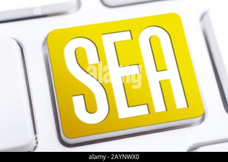 Yellow SEA Search Engine Advertising Button On A White Keyboard, Business Marketing Concept Stock Photo