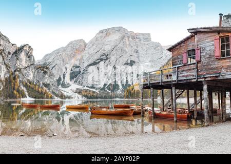 A magical panoramic landscape with calm colors of the famous lake Braies in the Dolomites Alps during autumn season. A popular tourist attraction Stock Photo