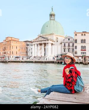 Happy asian woman travels in Venice. Great View on the famous tourist landmark Grand canal. Italy vacation concept Stock Photo