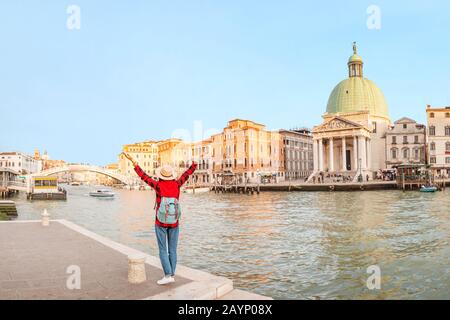 Happy asian woman travels in Venice. Great View on the famous tourist landmark Grand canal. Italy vacation concept Stock Photo