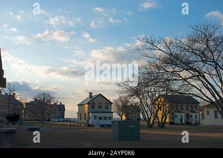 The sun sets past the Officer's Row Homes at Fort Hancock, Sandy Hook, New Jersey, leaving them in silhouettes -12 Stock Photo