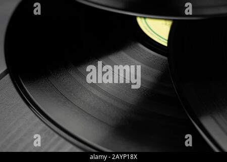 Stacked glossy vinyl records on which tracks of songs can be displayed Stock Photo