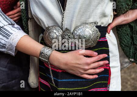 Traditional Bulgarian silver belt buckle on ladies costume. Antique belt buckles ottoman empire period. Stock Photo