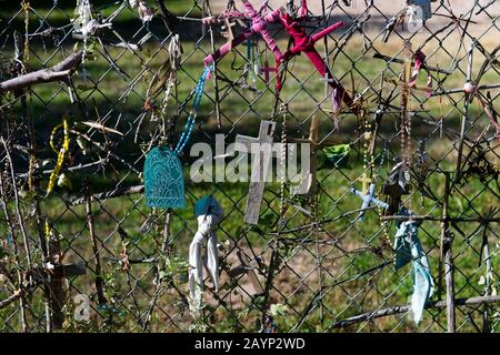 Crucifixes in the fence of the El Santuario de Chimayo in the small community of El Potrero just outside of Chimayo, New Mexico, USA. Stock Photo