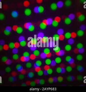 Abstract dot round glitter defocus background backdrop, green red violet. Illumination blurred light, abstract multicolored light flare geometric Stock Photo