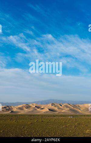 A herder ger camp in front of the Hongoryn Els sand dunes in the Gobi Desert in southern Mongolia. Stock Photo