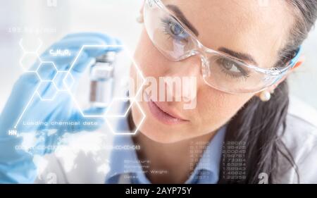 A young scientist examines a chemical substance. In front futuristic scientific interface with chemical formulas. Stock Photo