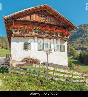 21 OCTOBER 2018, FUNES, ITALY: Typical Tyrol wooden alpine house architecture decorated with flowers Stock Photo