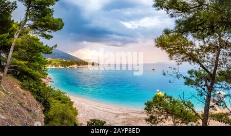 Coast in Bol, Brac island, Croatia. Scenic view with mountain, cliffs, pine trees and turquoise water of Adriatic Sea on sunny day. Famous tourist des Stock Photo