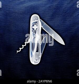 X ray X-ray Swiss army knife. Penknife with knives and corkscrew with its working revealed on a blue metal background. Stock Photo