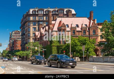 Boston, MA - June 2016, USA: Street view with historical houses made of brownstone and cars moving in Back Bay district of Boston Stock Photo