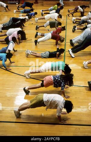Austin, Texas: Middle school students doing push-ups during physical education class.  ©Bob Daemmrich Stock Photo