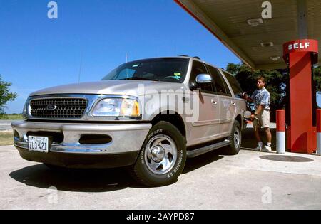 Austin, Texas: Man pumps gas into his Ford Expedition sport utility vehicle. Ford recently admitted that this model causes air pollution and is dangerous to other cars in collisions, but will continue to manufacture and sell the vehicle. ©Bob Daemmrich Stock Photo