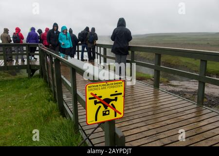 A sign not allowing to fly drones at the Gullfoss (Golden Falls) waterfall located in the canyon of the Hvita River in southwest Iceland, part of the Stock Photo