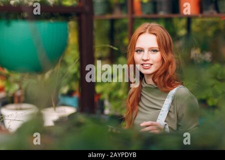 Home gardening concept. Young pretty woman gardener portrait. Spring home garden plant. Stock Photo