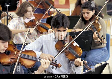 Austin, Texas: Students in string section of high school orchestra rehearse. ©Bob Daemmrich Stock Photo