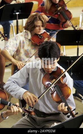 Austin, Texas: Students in string section of high school orchestra rehearse. ©Bob Daemmrich Stock Photo