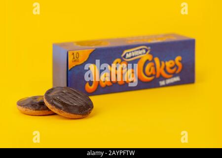 Some McVitie's Jaffa Cakes shot on a yellow background along with the product's box packaging. Stock Photo