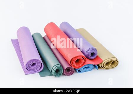 assortment of multicolored rugs for sport and yoga isolated on a white background Stock Photo