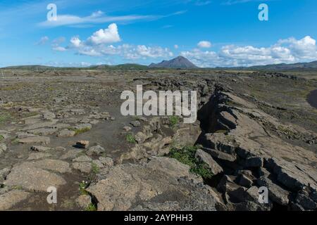 View of the top of Grjotagja, a small lava cave near Lake Myvatn with a thermal spring inside in Northeast Iceland. Stock Photo